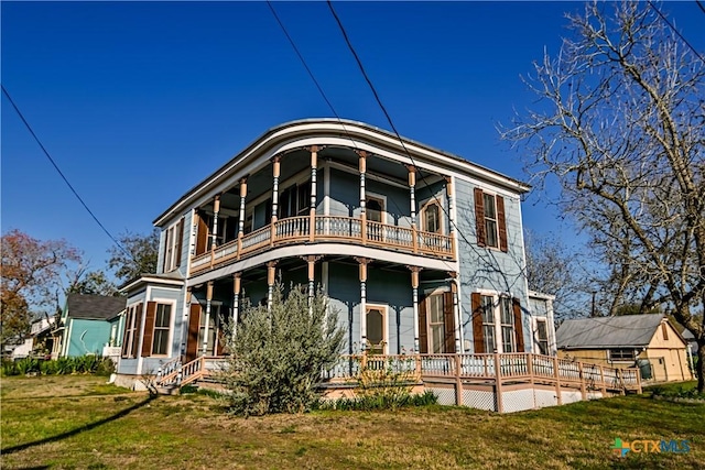 rear view of property with a lawn