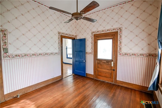 empty room featuring ceiling fan and dark wood-type flooring