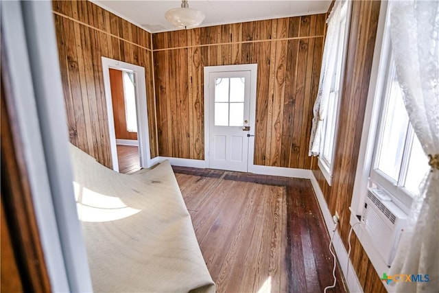 foyer featuring dark hardwood / wood-style flooring and wooden walls