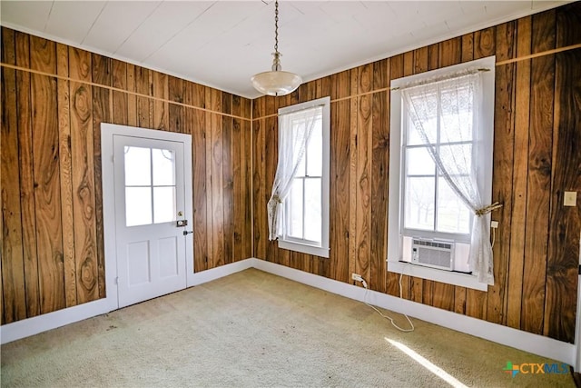 doorway featuring carpet, wood walls, a wealth of natural light, and cooling unit