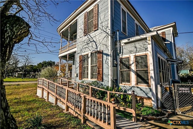 view of side of home with a balcony