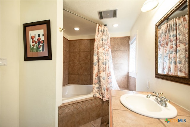 bathroom with shower / tub combo with curtain and vanity