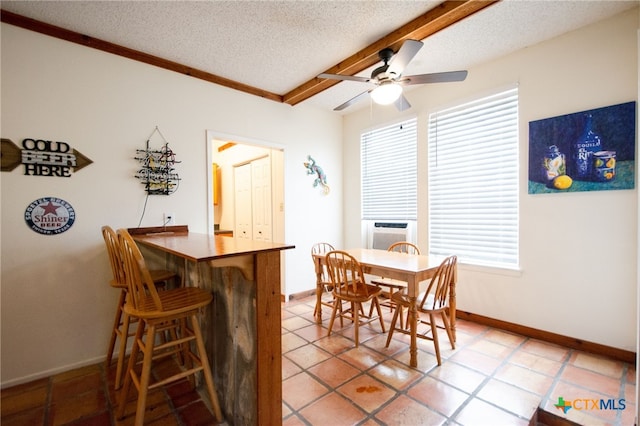 tiled dining room with ceiling fan, cooling unit, and a textured ceiling