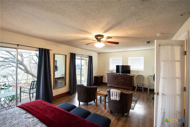 bedroom featuring ceiling fan, access to outside, a textured ceiling, and dark hardwood / wood-style flooring