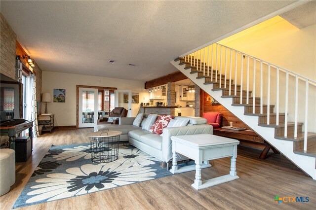 living room with wood-type flooring and a textured ceiling