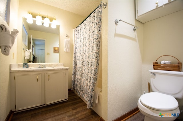 full bathroom featuring toilet, shower / tub combo, a textured ceiling, vanity, and hardwood / wood-style flooring