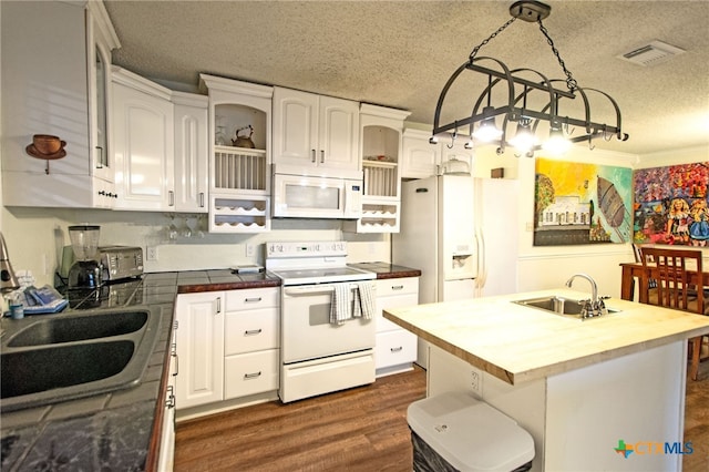 kitchen with white appliances, butcher block counters, sink, and white cabinets