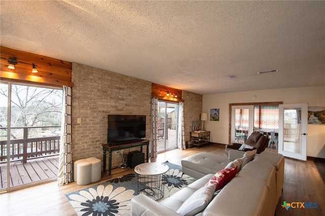 living room featuring wood-type flooring and a textured ceiling