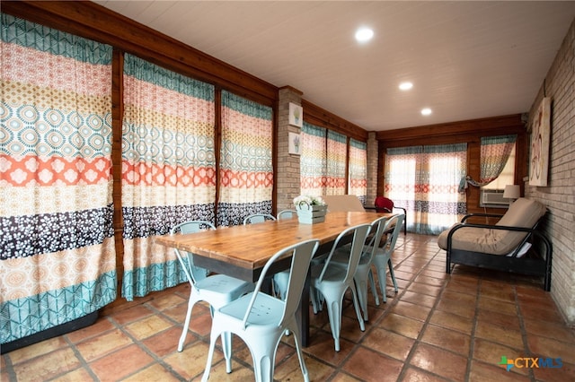 dining room with cooling unit and brick wall