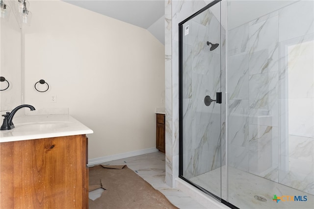 bathroom featuring vanity, walk in shower, and lofted ceiling