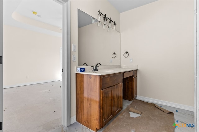 bathroom with vanity and a raised ceiling