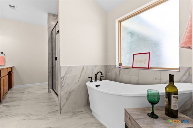 full bathroom featuring a stall shower, marble finish floor, and visible vents