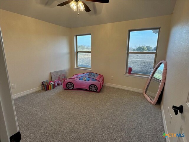 unfurnished bedroom with carpet floors, baseboards, and a ceiling fan