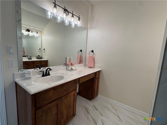 bathroom featuring marble finish floor, baseboards, and vanity