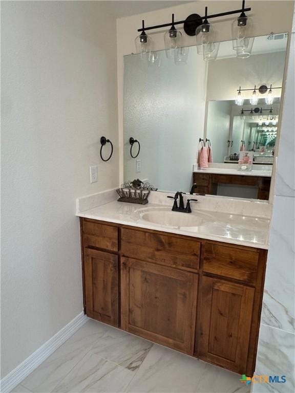 bathroom featuring visible vents, marble finish floor, vanity, and baseboards