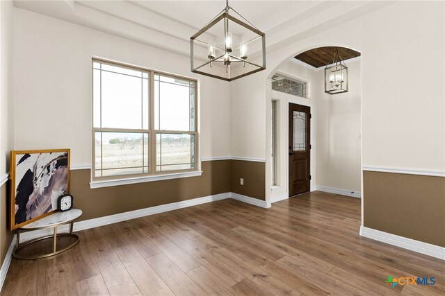 interior space with hardwood / wood-style flooring, ceiling fan, beam ceiling, and high vaulted ceiling