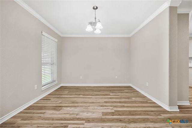 3301 Bonham Ave, Temple, TX 76502 - empty room featuring a chandelier, ornamental molding, light wood-style flooring, and baseboards