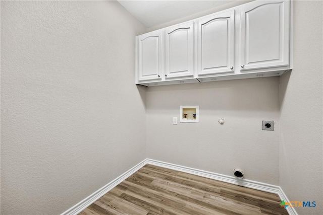 3301 Bonham Ave, Temple, TX 76502 - washroom featuring cabinet space, hookup for an electric dryer, washer hookup, baseboards, and gas dryer hookup
