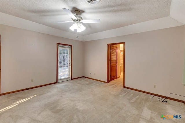 carpeted empty room with ceiling fan and a textured ceiling