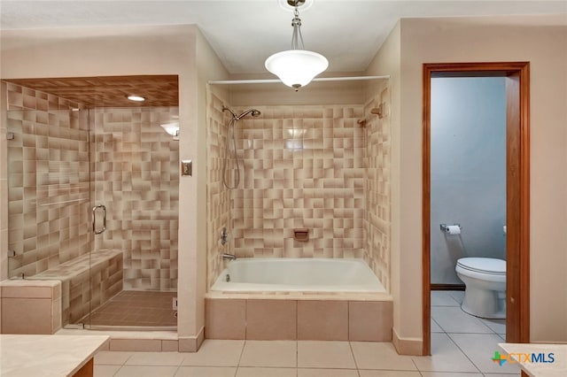 full bathroom with plus walk in shower, vanity, tile patterned floors, and toilet