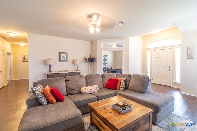 living room featuring hardwood / wood-style flooring and ceiling fan