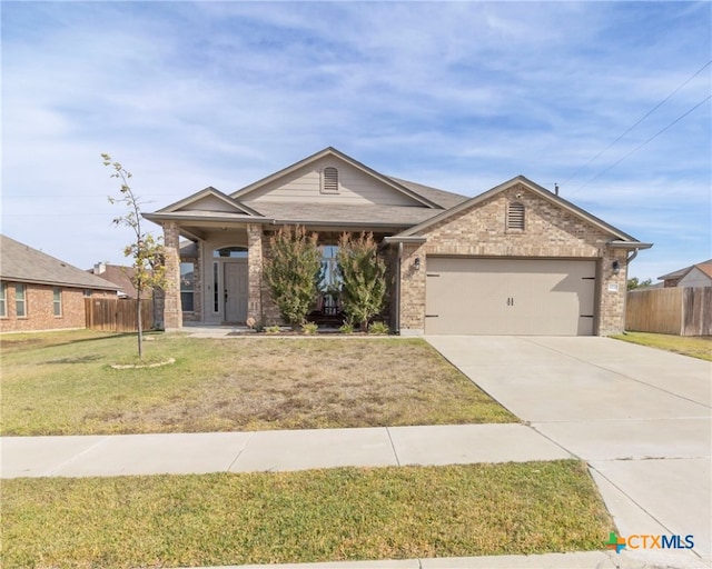 view of front of property with a garage and a front lawn