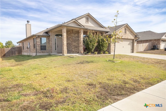 view of front of home featuring a front yard and a garage