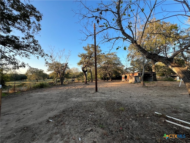 view of yard with a rural view