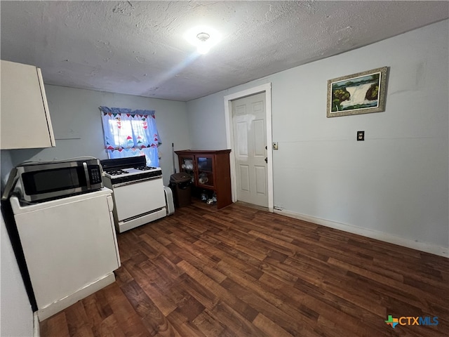 kitchen with a textured ceiling, white cabinets, dark wood-type flooring, and white range with gas cooktop