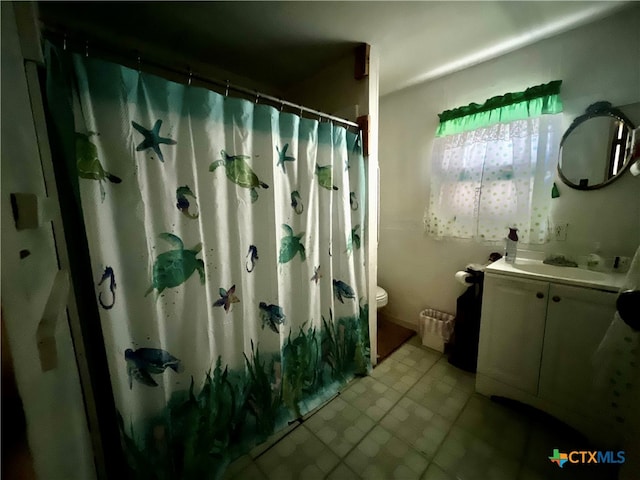 bathroom featuring vanity, toilet, and walk in shower