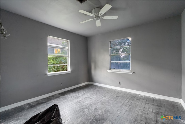 empty room featuring hardwood / wood-style floors and ceiling fan