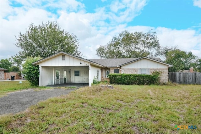 709 Pheasant Dr, Victoria, TX 77905 - single story home with asphalt driveway, brick siding, and board and batten siding
