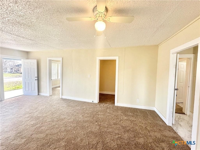 unfurnished room with baseboards, carpet floors, and a textured ceiling