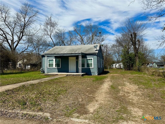 bungalow featuring a front yard and fence