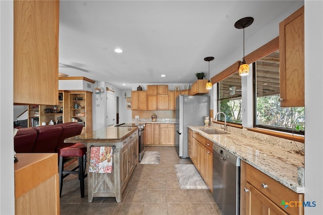 1400 Willow Dr, Canyon Lake, TX 78133 - kitchen with stainless steel appliances, light stone countertops, recessed lighting, decorative light fixtures, and open floor plan