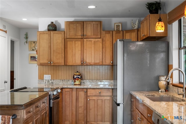 1400 Willow Dr, Canyon Lake, TX 78133 - kitchen with stainless steel appliances, light stone countertops, brown cabinetry, hanging light fixtures, and recessed lighting