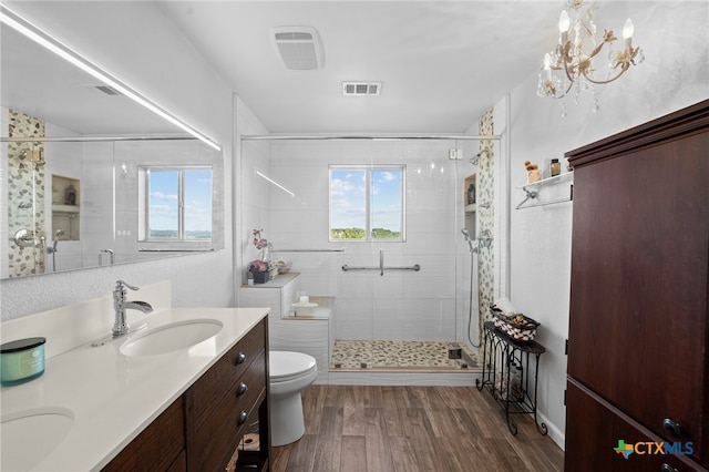 1400 Willow Dr, Canyon Lake, TX 78133 - full bathroom featuring a shower stall, double vanity, wood finished floors, and a chandelier