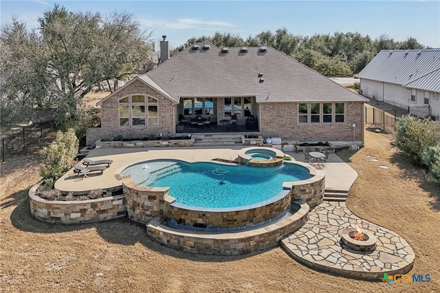 view of pool with an outdoor fire pit, a patio area, a fenced backyard, and a pool with connected hot tub