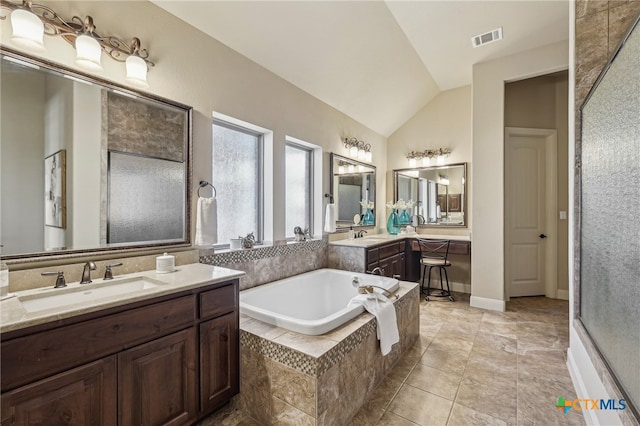 full bathroom featuring visible vents, lofted ceiling, two vanities, a sink, and a bath