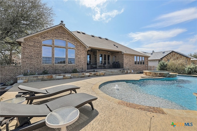 view of pool with a pool with connected hot tub and a patio