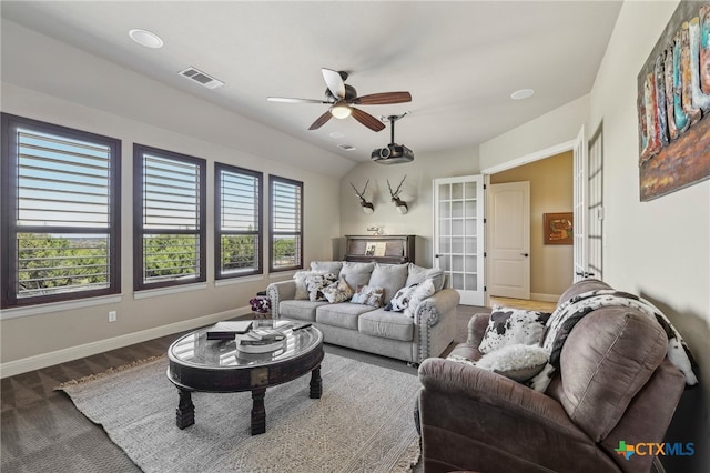 living area featuring baseboards, visible vents, a ceiling fan, and wood finished floors