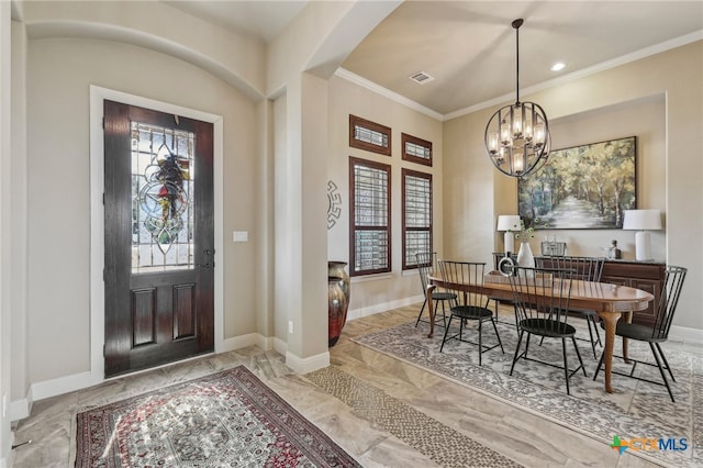 entrance foyer with marble finish floor, crown molding, a notable chandelier, visible vents, and baseboards