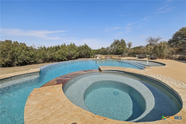 view of pool featuring a pool with connected hot tub