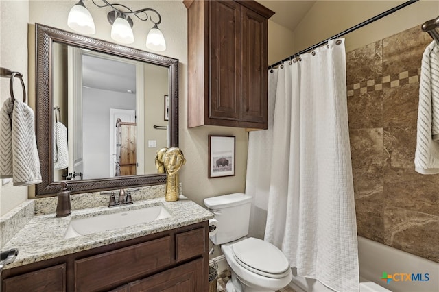 bathroom featuring toilet, shower / tub combo with curtain, and vanity