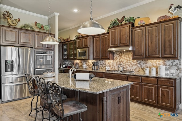 kitchen featuring ornamental molding, appliances with stainless steel finishes, light stone countertops, and decorative backsplash