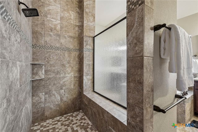 full bath with a tile shower