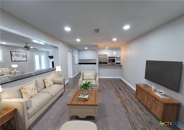 living room featuring dark hardwood / wood-style flooring and ceiling fan