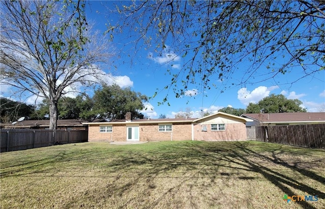 back of property featuring a lawn