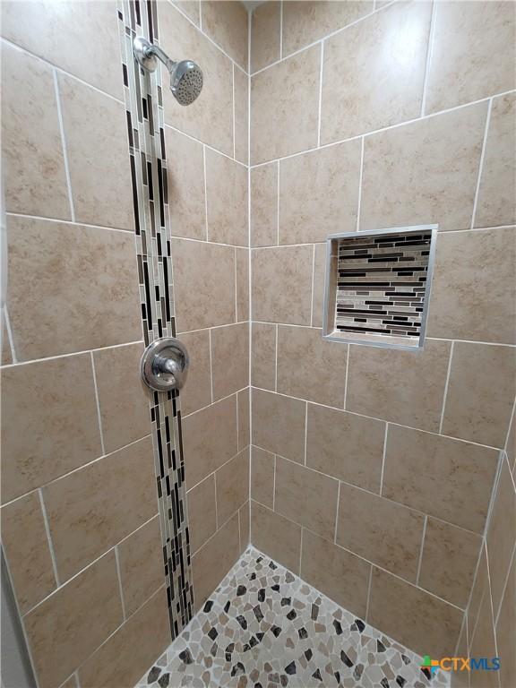 bathroom with tiled shower