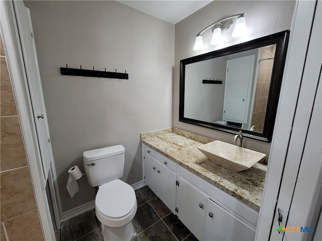 bathroom featuring toilet and vanity